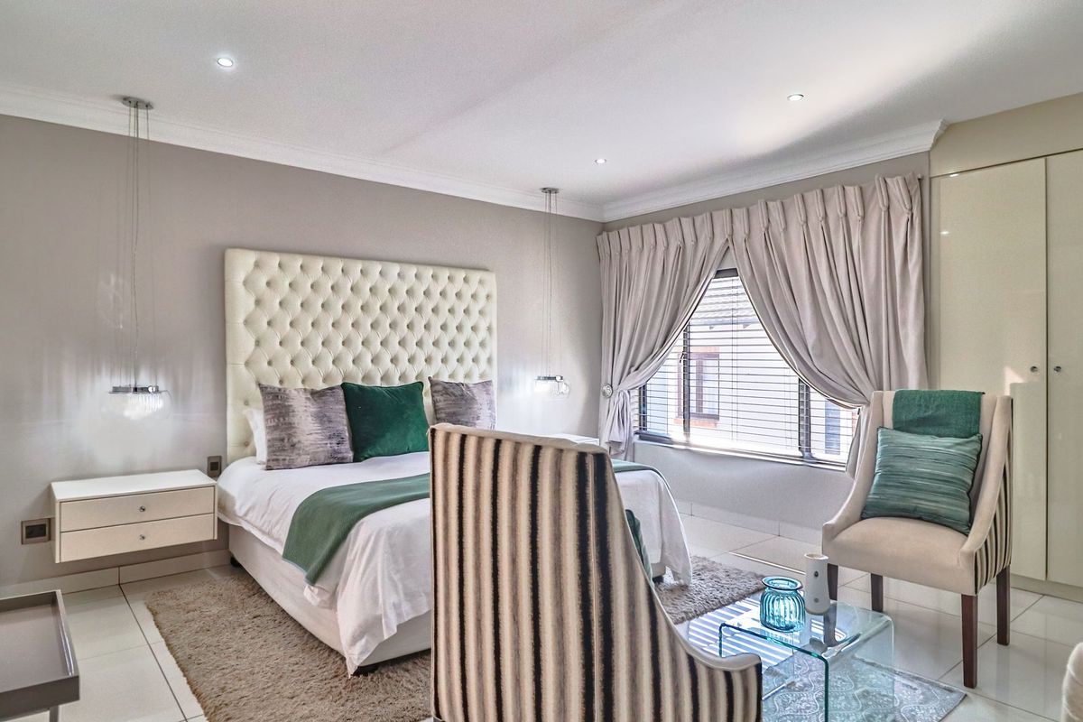 A well-maintained bedroom featuring tiled flooring, recessed ceiling lighting, and built-in cabinetry, offering a clean and comfortable living space.