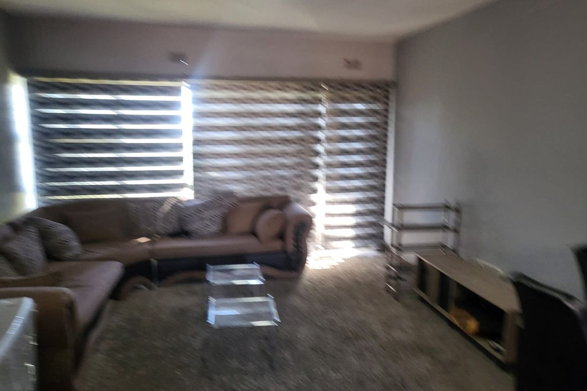 A living room area featuring fitted roller blinds, providing a functional space for relaxation.