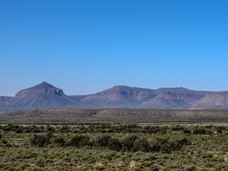 Expansive panoramic view of the surrounding mountain range and natural landscape, showcasing the scenic beauty of the farm property.