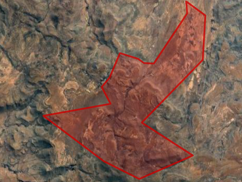 An aerial satellite view showing the boundary outline of the farm property across the natural landscape.