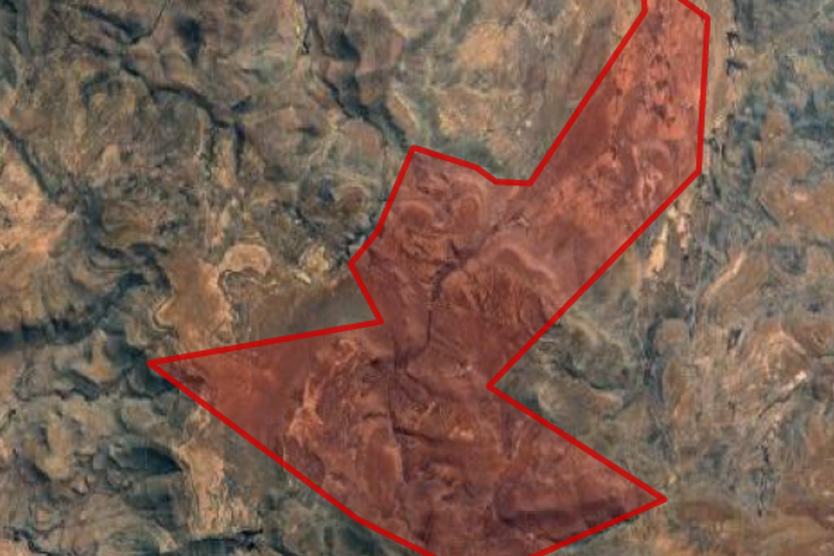 An aerial satellite view showing the boundary outline of the farm property across the natural landscape.