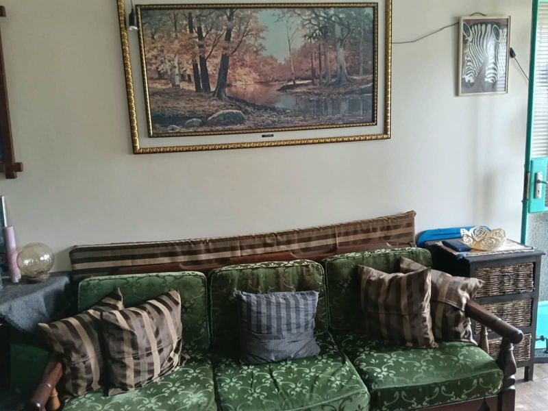 A living room area featuring neutral wall finishes, suitable for modernization and updated interior design.