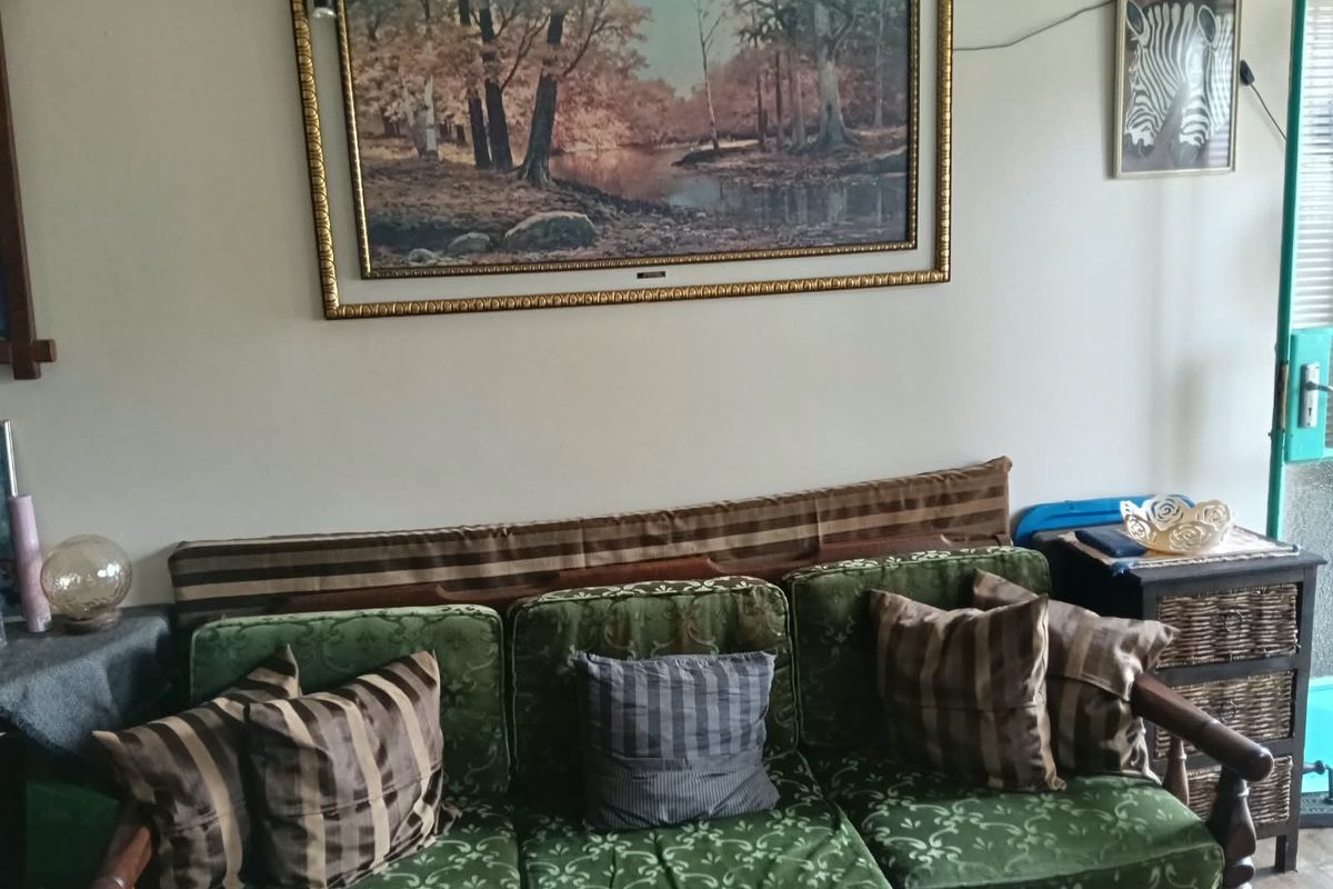 A living room area featuring neutral wall finishes, suitable for modernization and updated interior design.