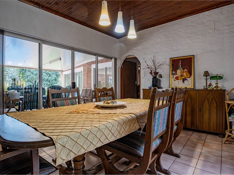 Dining room featuring a timber ceiling, tiled floors, and large sliding glass doors providing access to the patio area.