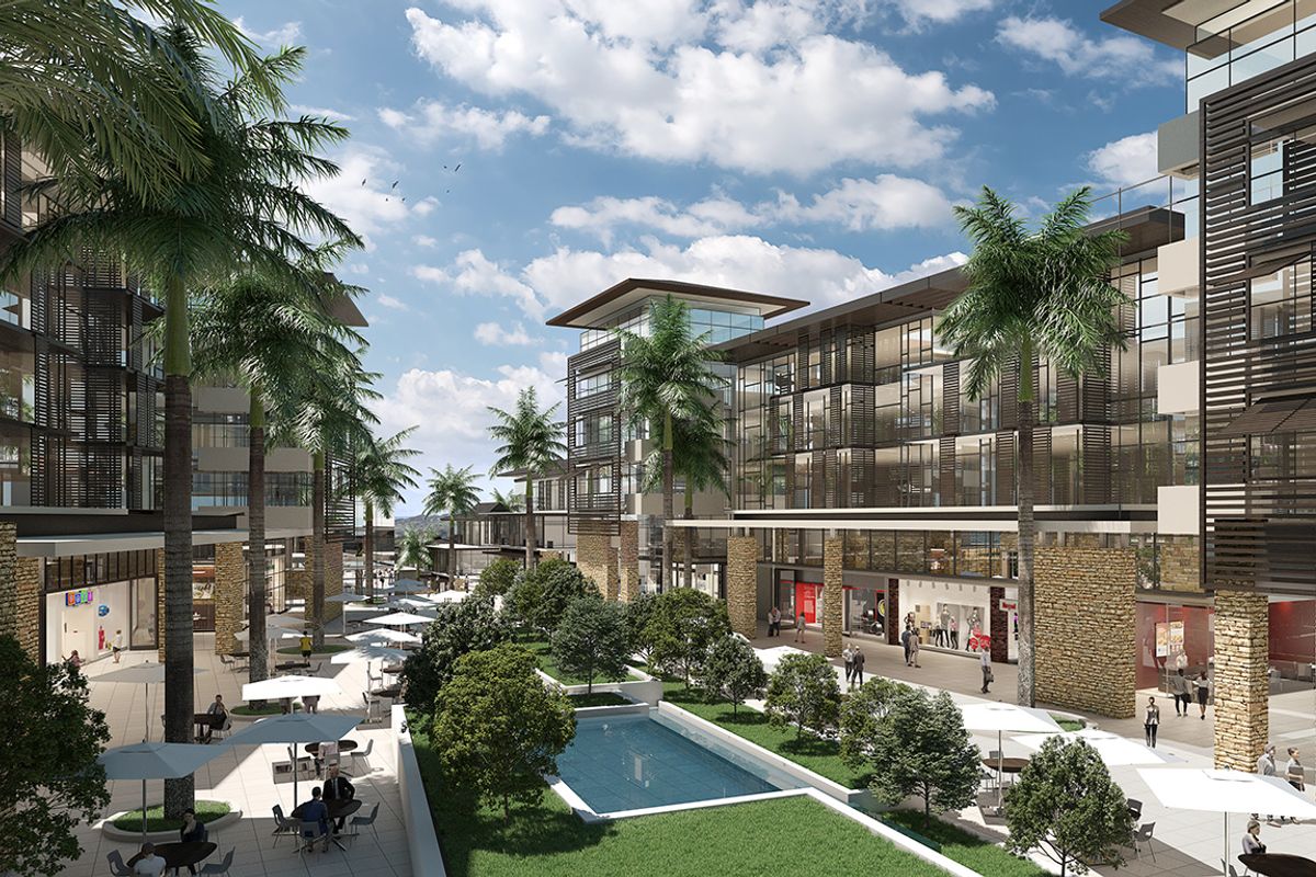 A modern apartment complex courtyard featuring stone-clad pillars, glass-fronted buildings with louvre screens, landscaped gardens, and a central water feature.