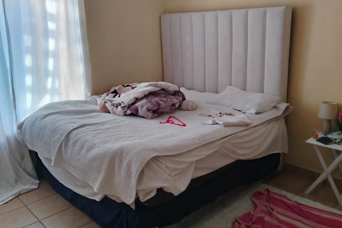 A standard bedroom featuring tiled flooring and neutral wall tones, providing a functional space ready for personalization.