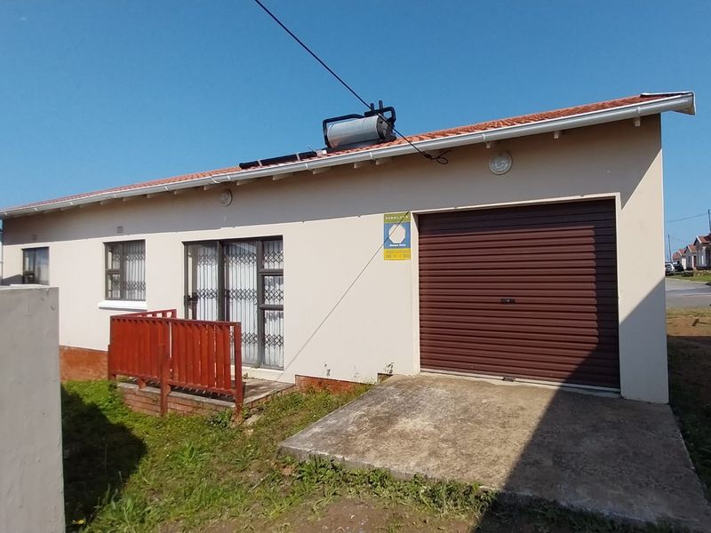 Rear exterior view of the property featuring a single garage, solar water heating system, and security gates on the sliding doors.