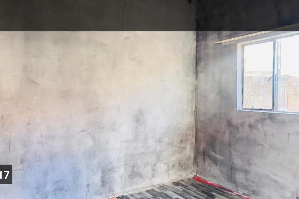 An unfinished bedroom interior featuring raw plastered walls and exposed flooring, awaiting final finishes and decoration.