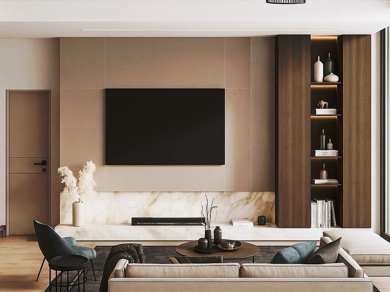 Modern living room featuring a marble fireplace hearth, integrated wood cabinetry with display shelving, and recessed lighting.