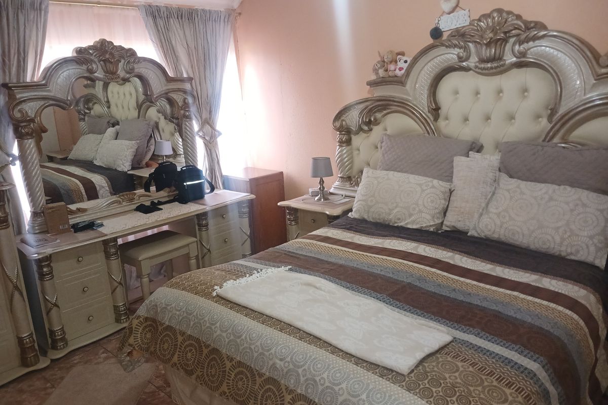 A bedroom featuring tiled flooring and curtain rails, providing a functional space for rest.