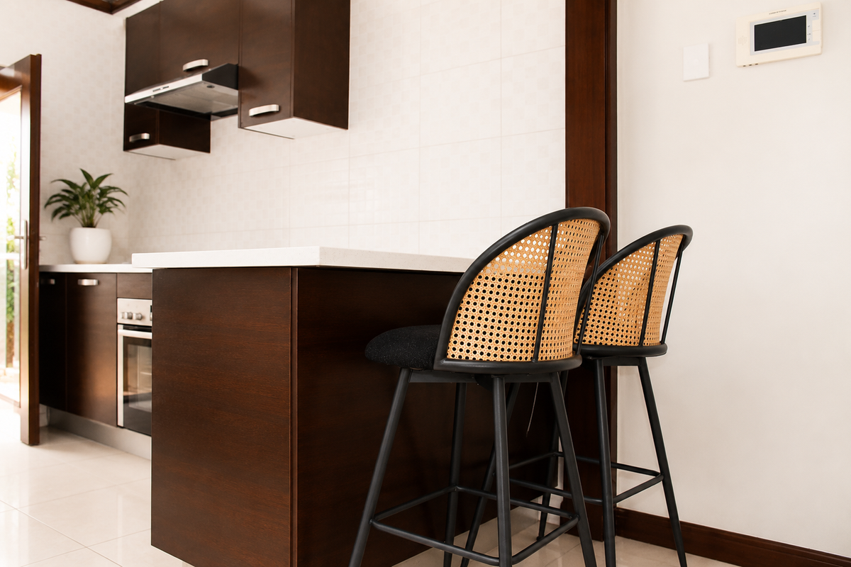 Modern kitchen featuring dark wood cabinetry, stone countertops, built-in oven, and an integrated extractor fan with a clean tiled backsplash.
