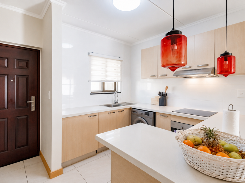 Modern kitchen featuring light wood cabinetry, stone countertops, integrated appliances, and a sleek tiled finish, offering a clean and functional culinary space.