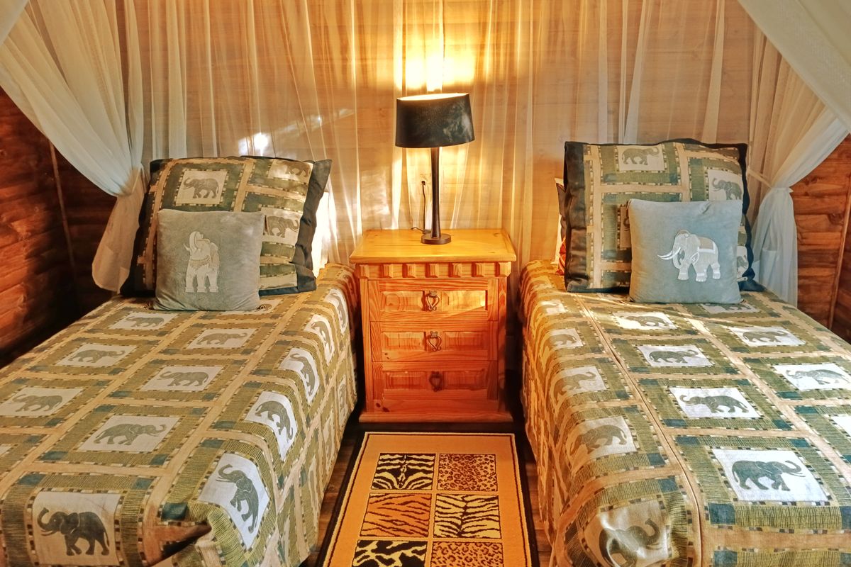 A cozy bedroom featuring warm timber wall cladding and timber flooring, creating a rustic and inviting atmosphere.