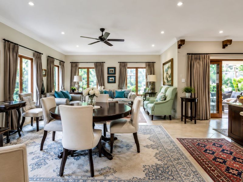Spacious open-plan living and dining area featuring tiled floors, recessed lighting, a ceiling fan, and large sliding doors providing access to the outdoor space.