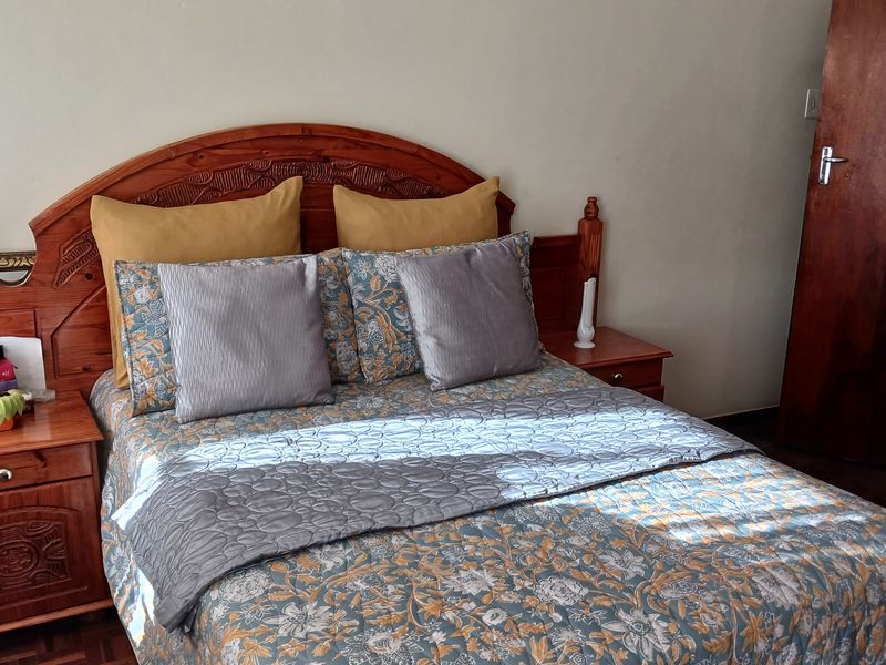 A bedroom featuring parquet flooring and a solid wood door, providing a classic foundation for the living space.