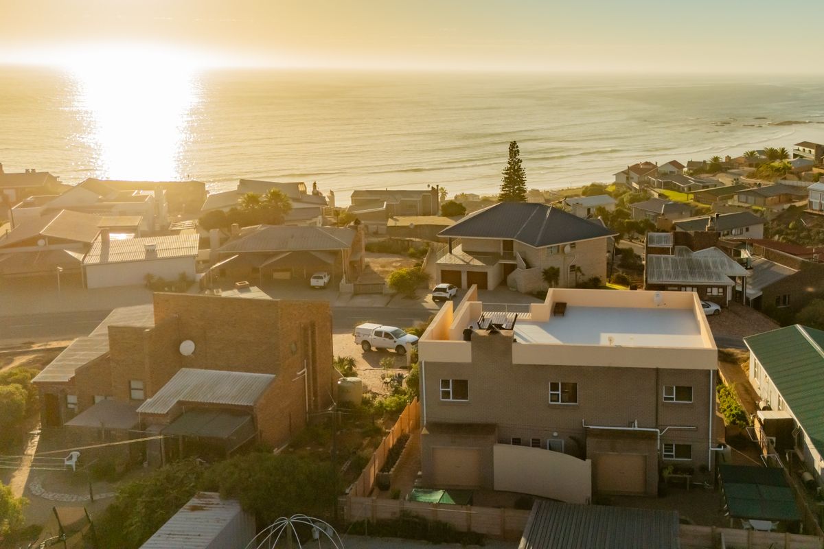 An aerial view of the coastal residential neighborhood, highlighting the property's location and proximity to the ocean.