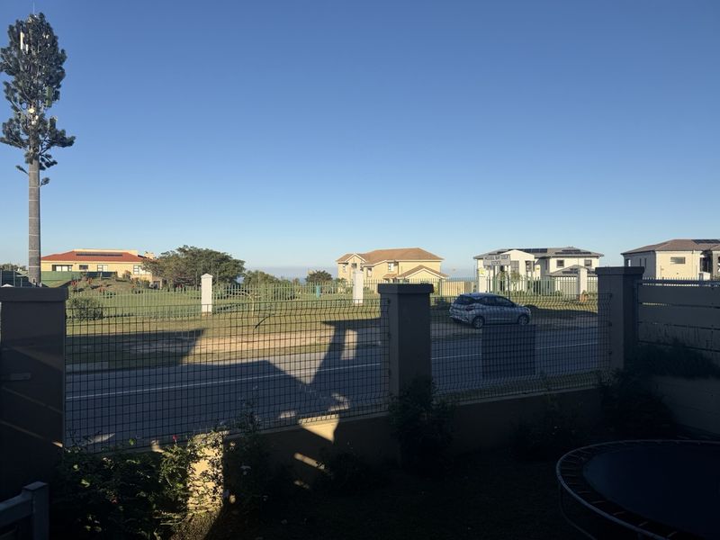 Lovely family home with beautiful views in a safe complex across the Mossel Bay golf estate - Photo 1