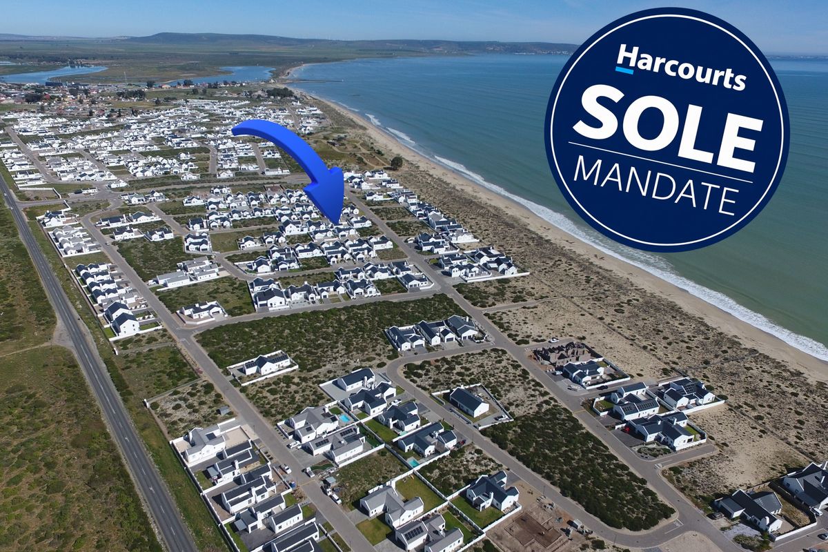Aerial view of a coastal residential estate, highlighting the property's proximity to the beach and surrounding neighbourhood layout.