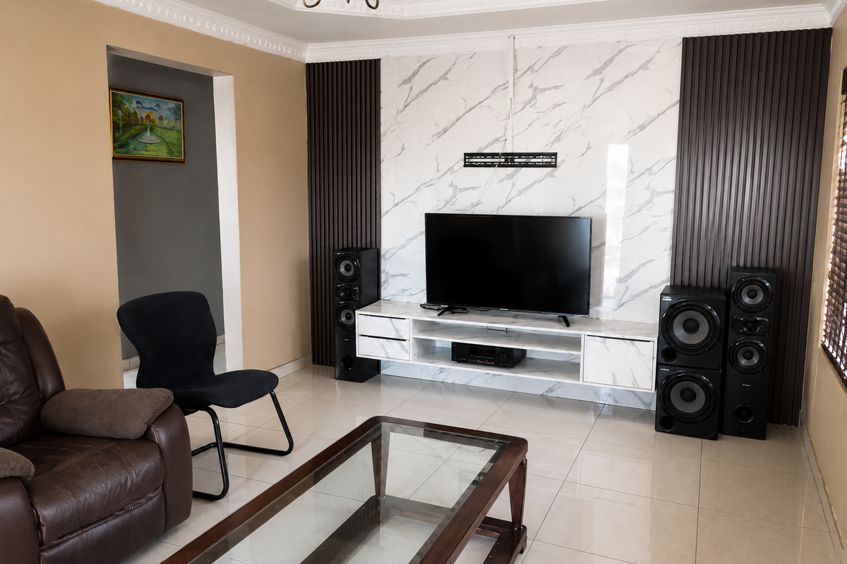 A modern living room featuring a marble-effect feature wall with vertical timber accents, a floating media console, and polished tiled flooring.