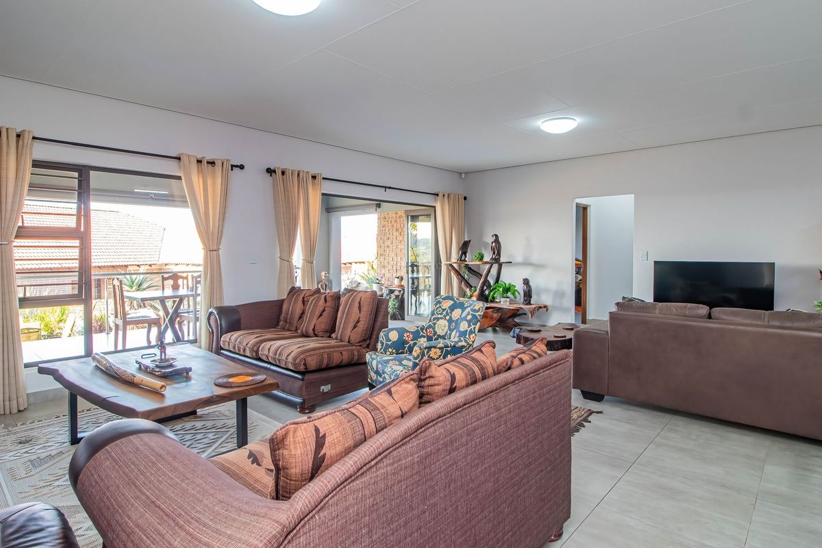 Spacious living room featuring large sliding glass doors that provide natural light and access to the outdoor patio area.