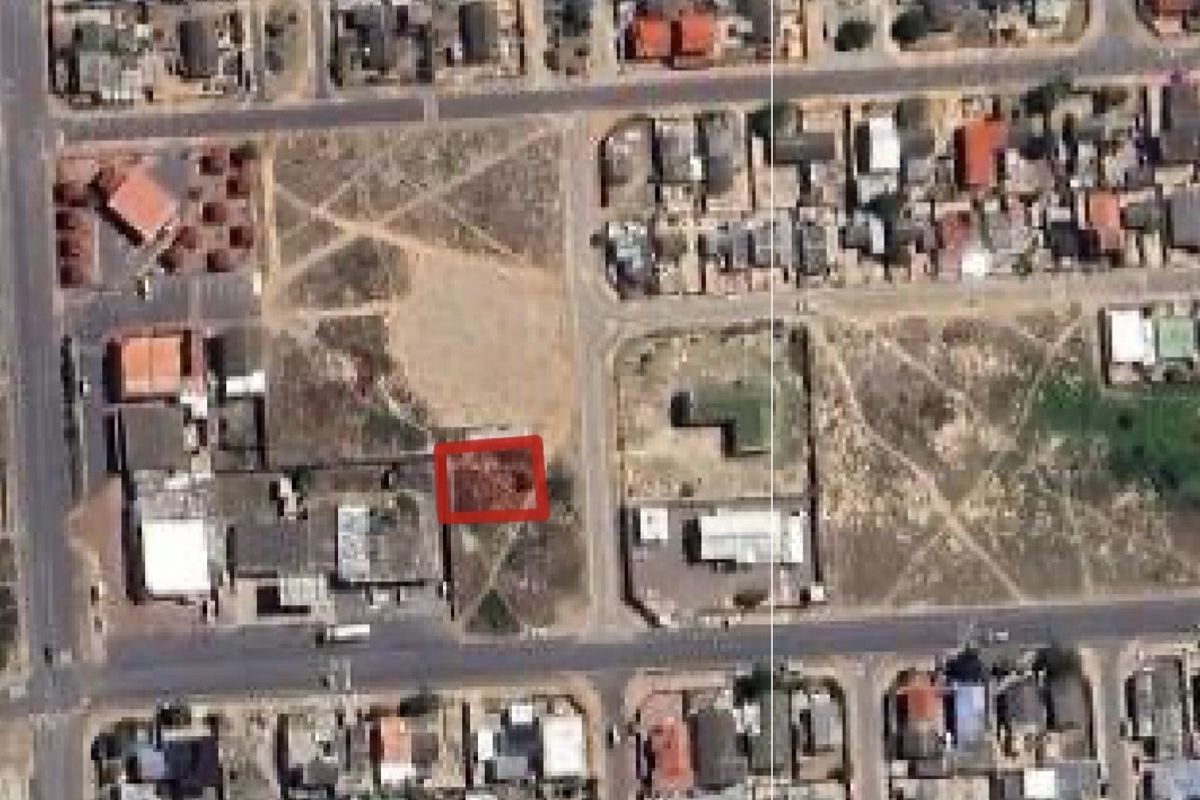 An aerial view of a residential neighborhood highlighting a specific vacant land plot within the urban layout.