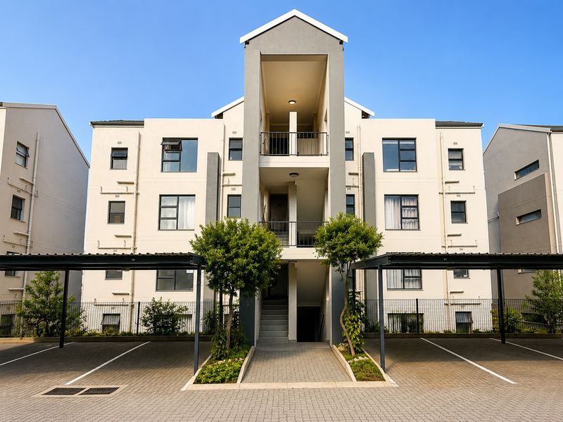 Front elevation of a modern apartment complex featuring paved parking carports, central stairwell access, and private balconies for upper-level units.