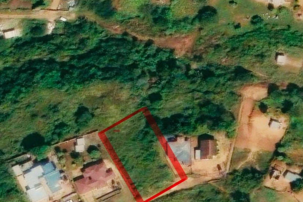 Aerial view of a vacant residential land plot situated within an established neighborhood.