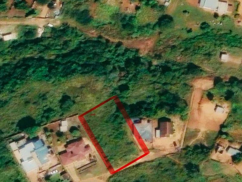Aerial view of a vacant residential land plot situated within an established neighborhood.