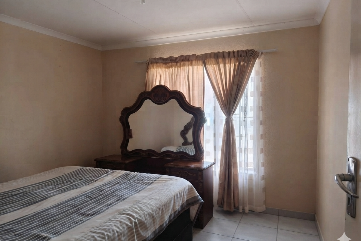 A bedroom featuring tiled flooring and a coved ceiling, requiring cosmetic updates to improve the overall aesthetic and condition of the space.