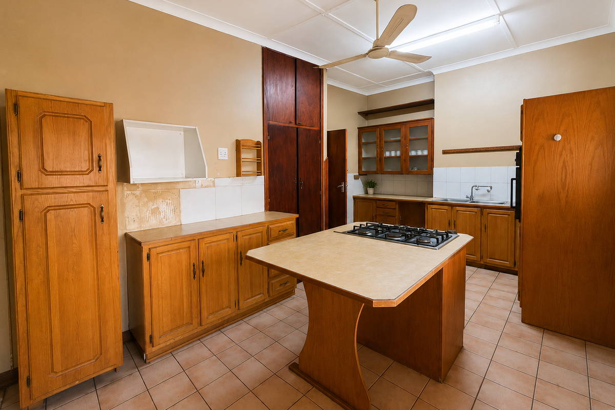 A dated kitchen featuring wooden cabinetry, a central island with a gas cooktop, tiled flooring, and a functional layout ready for modernization.