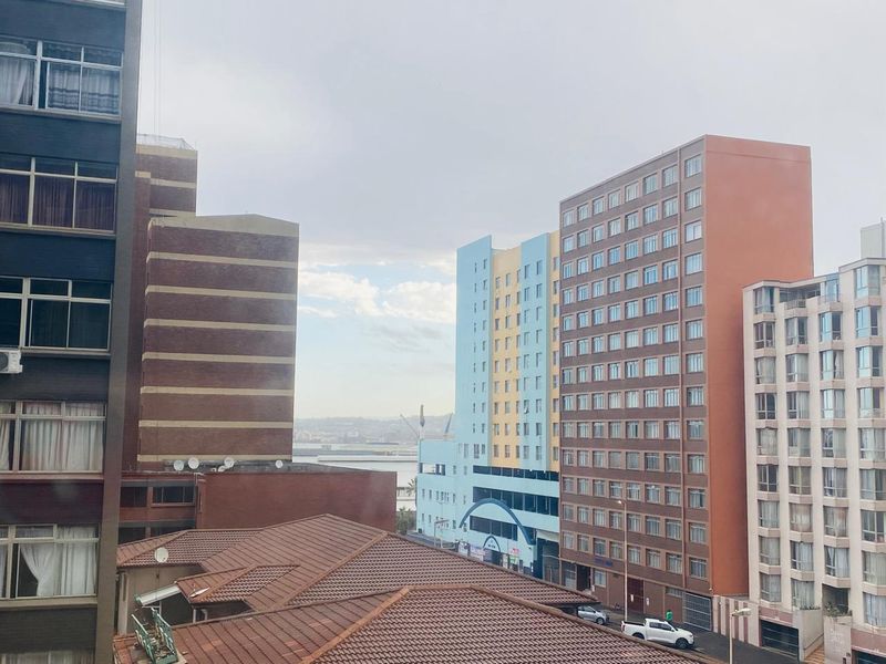 An elevated urban view overlooking surrounding apartment buildings and city infrastructure.