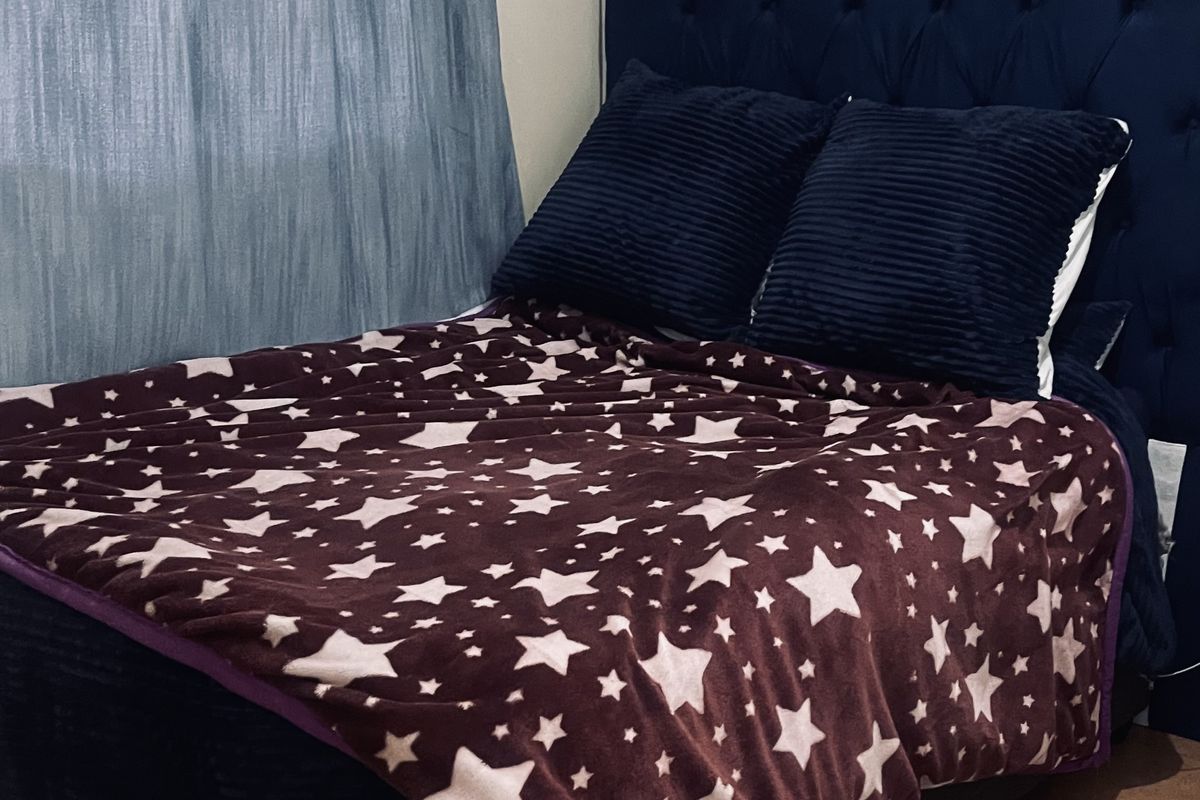 A bedroom featuring tiled flooring and a curtain rod, providing a functional space ready for personalization.