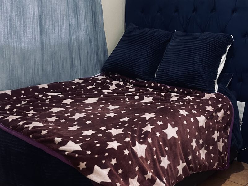 A bedroom featuring tiled flooring and a curtain rod, providing a functional space ready for personalization.
