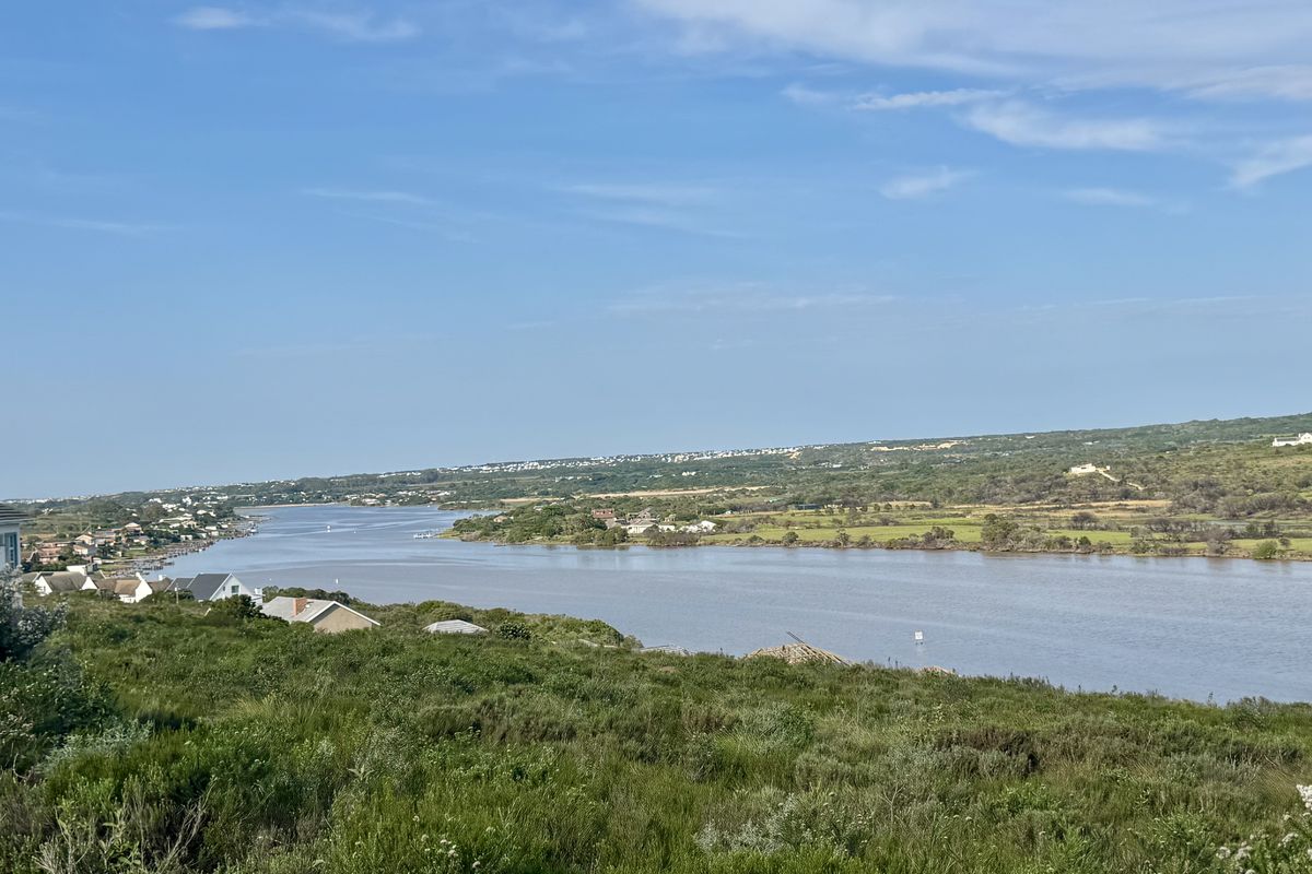 A scenic elevated view overlooking a river estuary and surrounding coastal landscape.