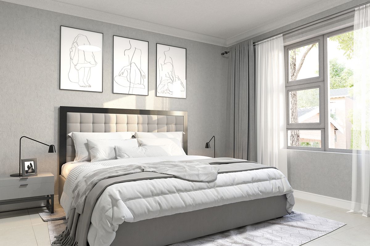 A well-lit, modern bedroom featuring neutral tones, clean lines, and large windows allowing for natural light.