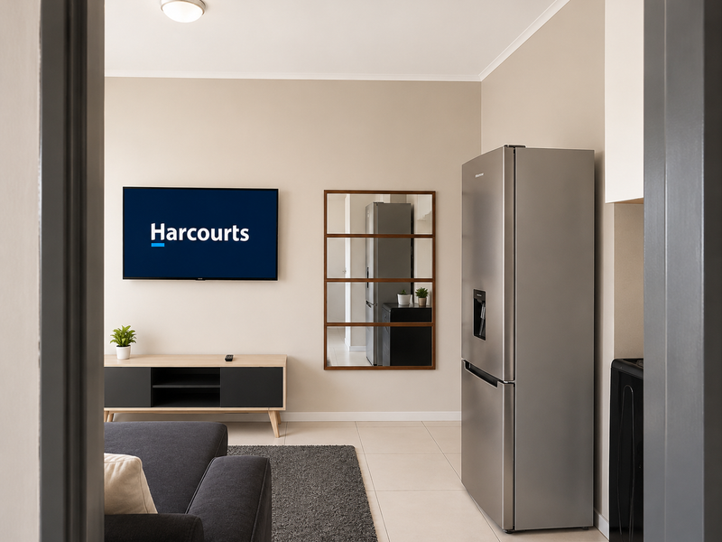 A well-maintained open-plan living area featuring neutral wall tones and tiled flooring, providing a clean and functional space.