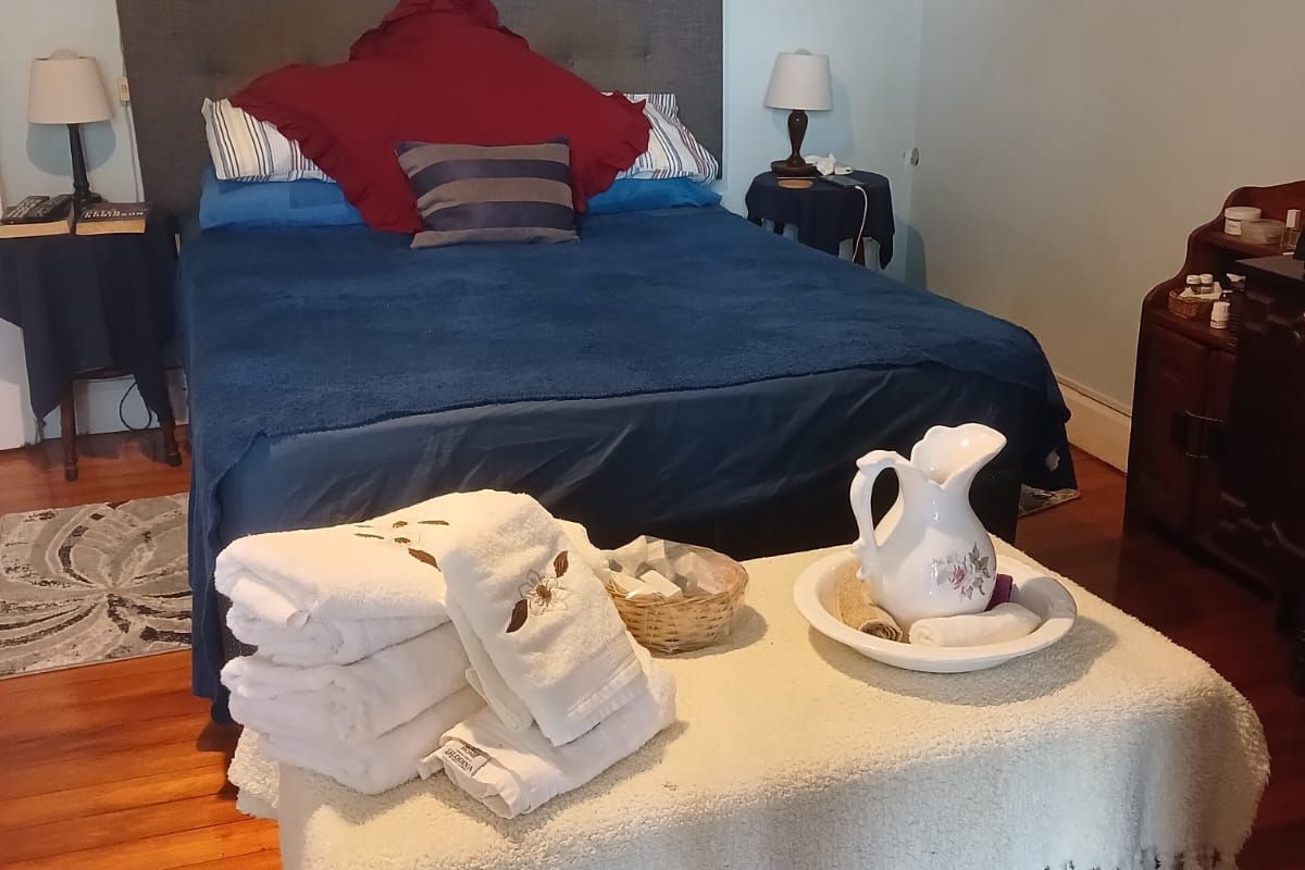 A bedroom featuring polished hardwood flooring and crown molding, providing a classic foundation for interior updates.