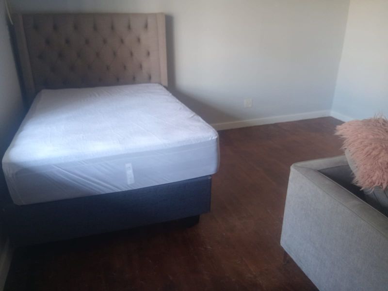 A bedroom featuring hardwood flooring and neutral wall finishes, providing a functional space ready for personalization.