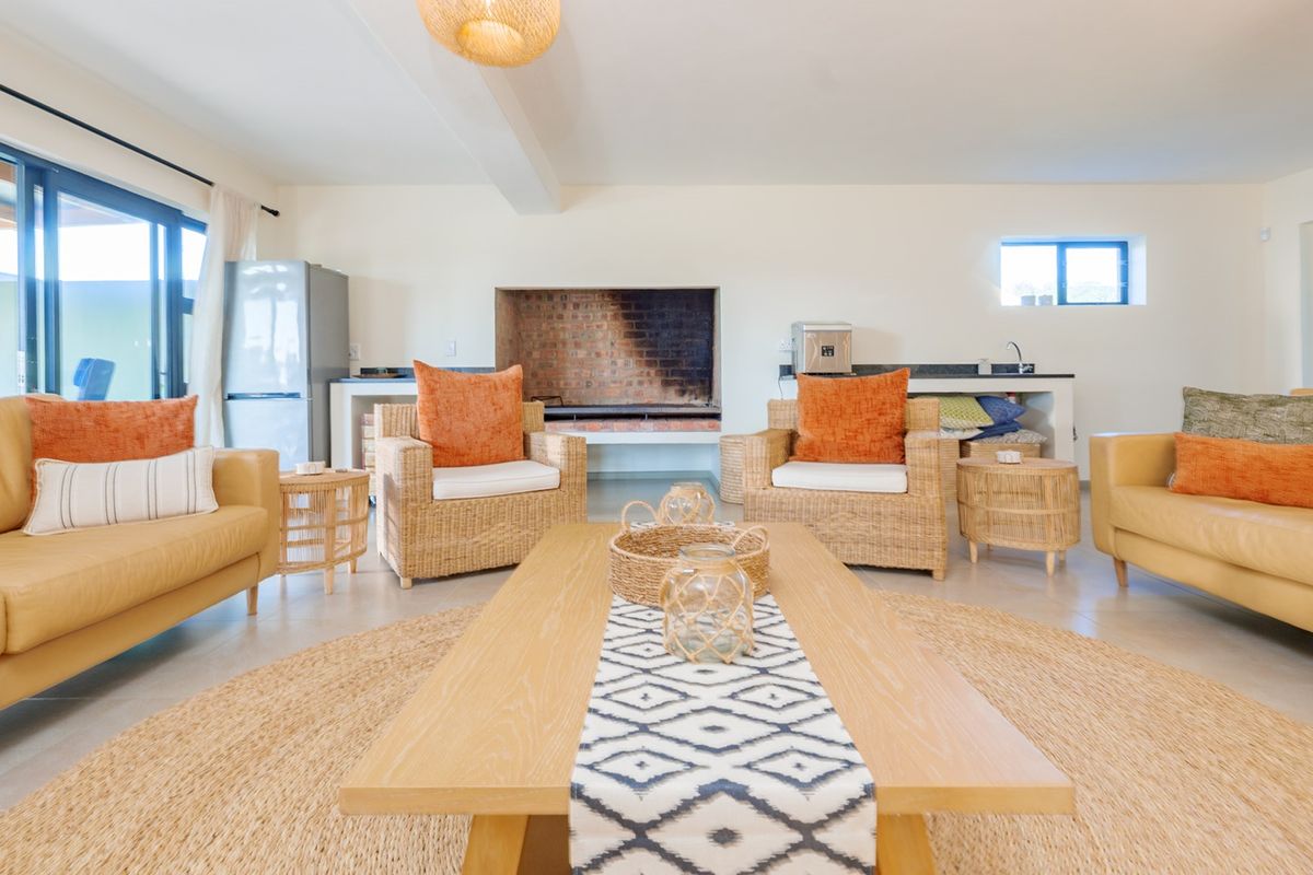 Spacious living area featuring a built-in fireplace, tiled flooring, and large sliding glass doors that provide access to the outdoor space.