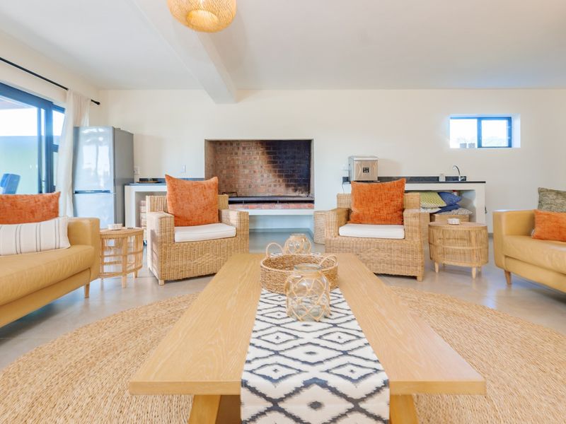 Spacious living area featuring a built-in fireplace, tiled flooring, and large sliding glass doors that provide access to the outdoor space.