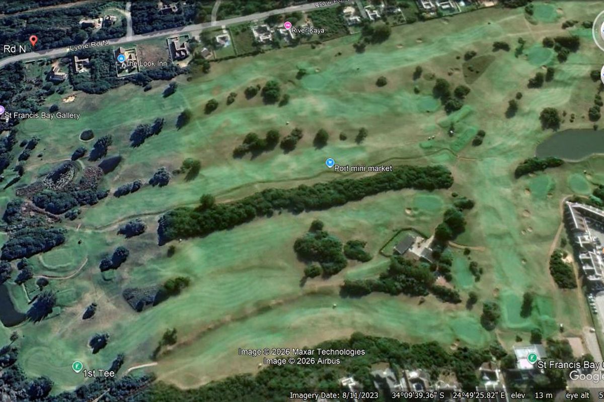 An aerial view of the surrounding golf course landscape and residential area.