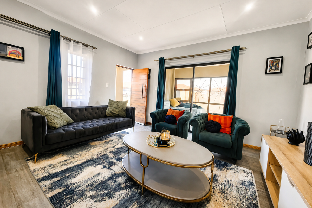 A bright and well-maintained living room featuring modern laminate flooring, recessed lighting, and large sliding glass doors providing access to the outdoor area.