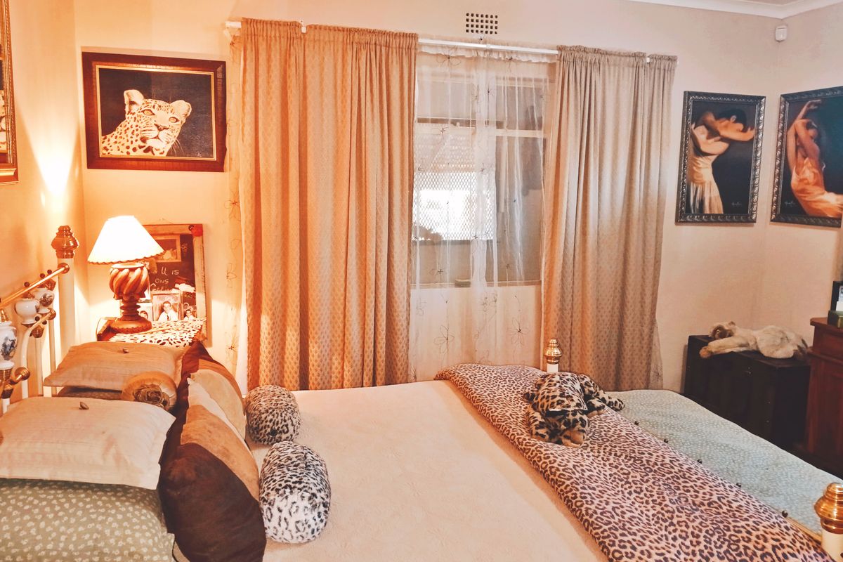 A bedroom featuring a window with curtains and decorative coving, providing a functional space for rest.