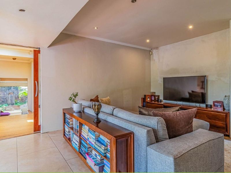 Living room featuring tiled flooring, recessed lighting, and direct access to an outdoor area via a sliding glass door.