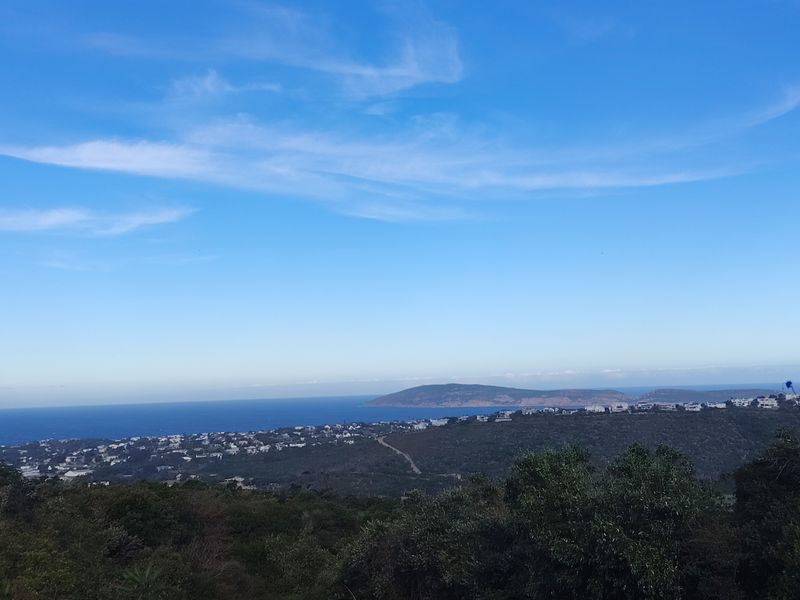 A scenic elevated view overlooking the coastal landscape, surrounding residential area, and the ocean horizon.