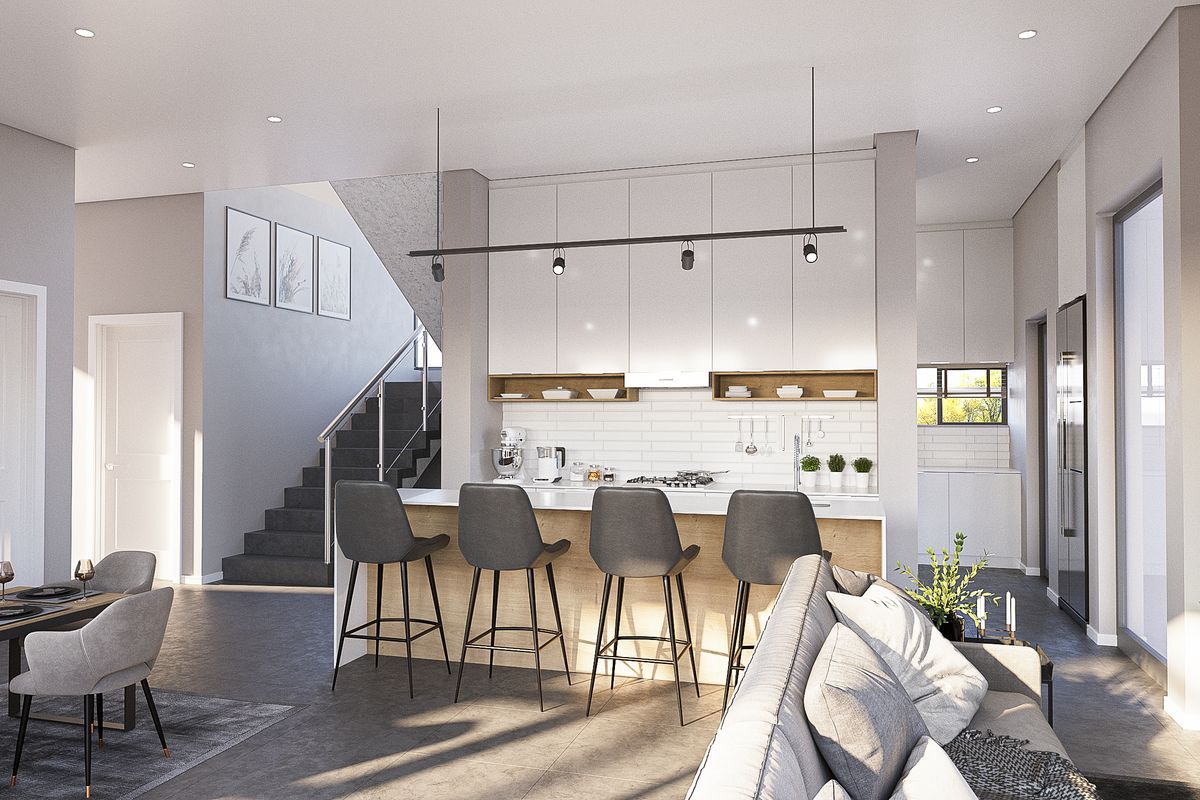 Modern open-plan living area featuring a contemporary kitchen with a central island, sleek cabinetry, and an integrated staircase leading to the upper level.