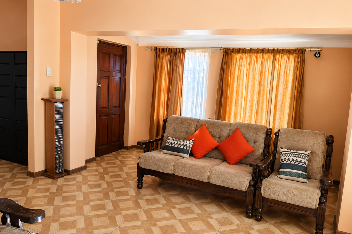 A living room featuring tiled flooring, a wooden door, and curtain-covered windows, providing a functional and traditional living space.