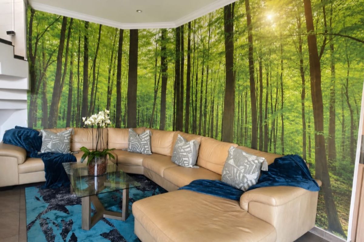 Living room featuring a prominent forest-themed wall mural, built-in wooden cabinetry, and a modern staircase with tiled flooring.
