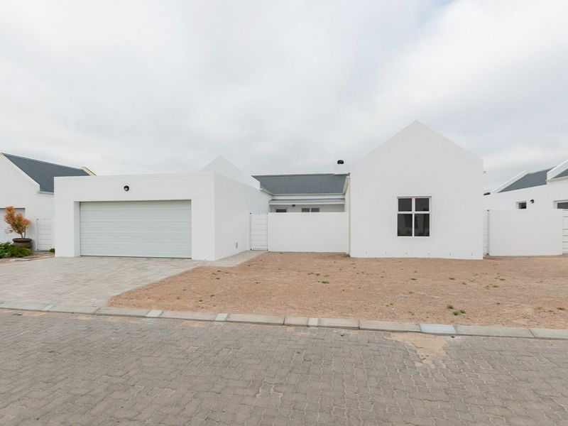 Front elevation of a modern white house featuring a single garage, paved driveway, and a clean, minimalist architectural design.