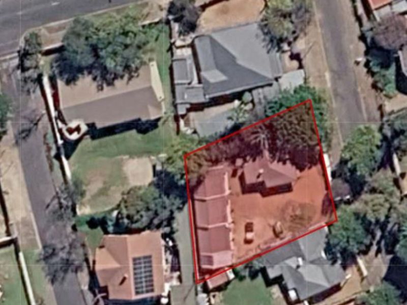 An aerial satellite view showing the property layout, roof structure, and surrounding residential plot boundaries.
